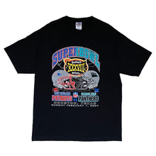 Load image into Gallery viewer, black shirt. superbowl xxxviii. split graphic where the side of the patriots is blue and the panther side is baby blue. has patriot helmet and panther helmet. patriots vs. panthers. houston, texas. sunday, february 1, 2004
