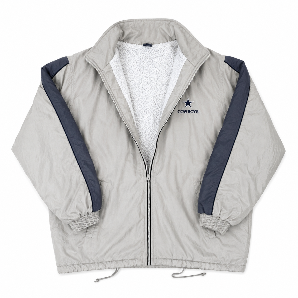 A light tan zip-up windbreaker jacket with a white sherpa lining, navy blue sleeve stripes, and a Dallas Cowboys logo on the left chest, displayed flat against a white background.