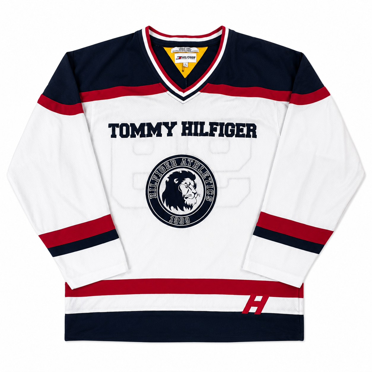 A white Tommy Hilfiger hockey jersey with navy and red stripes, featuring the 'TOMMY HILFIGER' text and the 'Troy Jackson 1991' crest on the front.