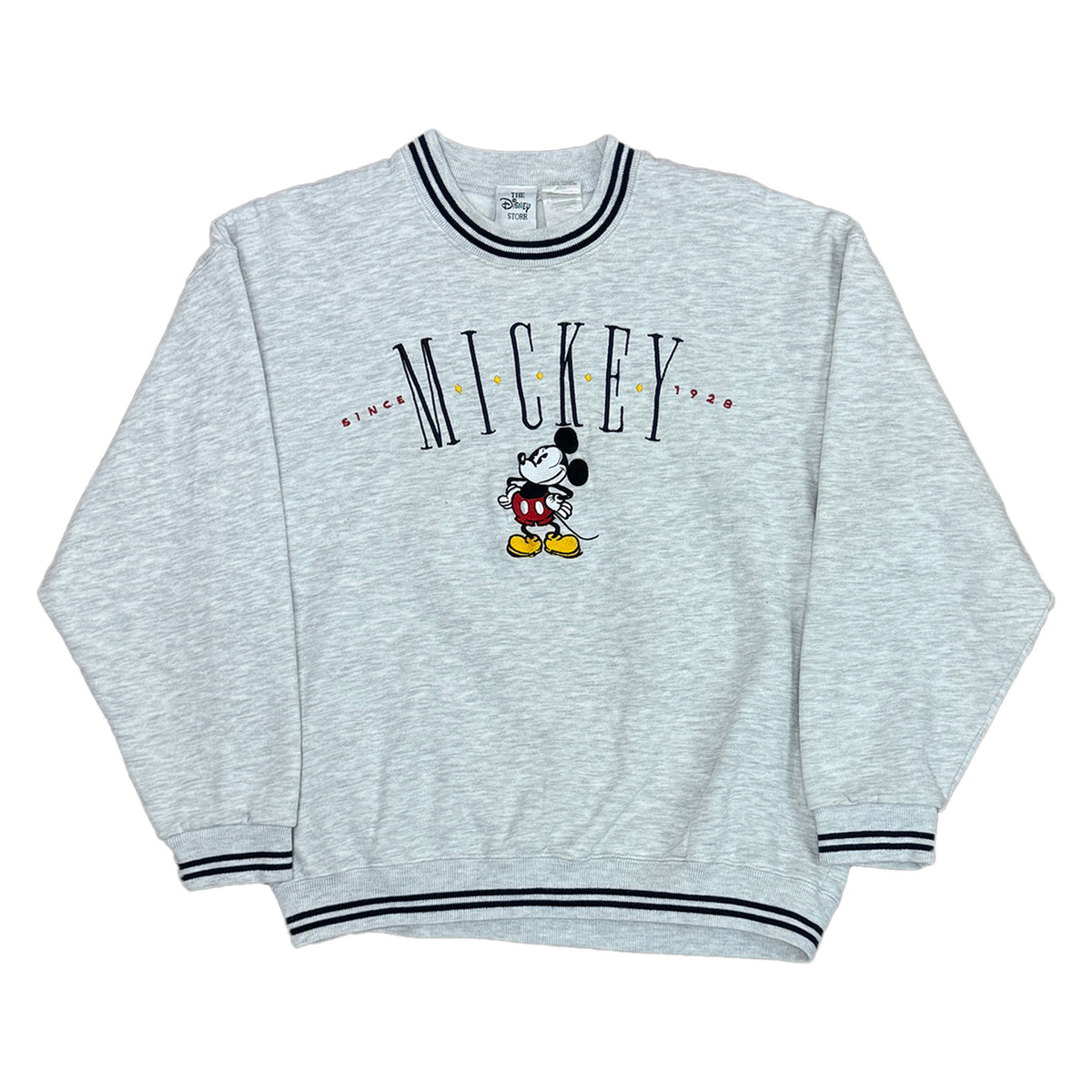 heather grey pullover with the word mickey on the chest that says since 1928. mickey mouse posing on the front. ribbing is gray with navy stripes