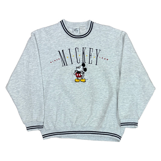 heather grey pullover with the word mickey on the chest that says since 1928. mickey mouse posing on the front. ribbing is gray with navy stripes