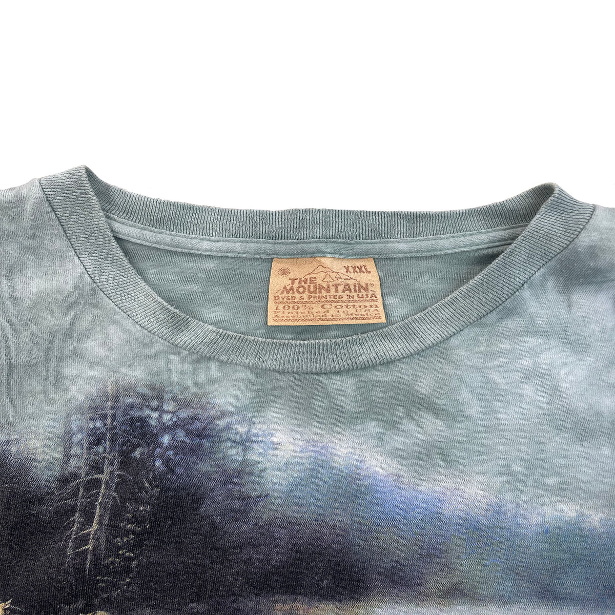 photo of the mountain shirt tage on the collar. says xxxl the mountain dyed and printed in usa. 100% cotton finished in the usa.