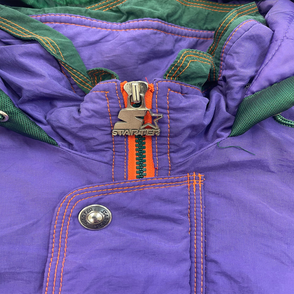 CLOSE UP OF THE LOGO ZIPPER WHICH IS STARTER.